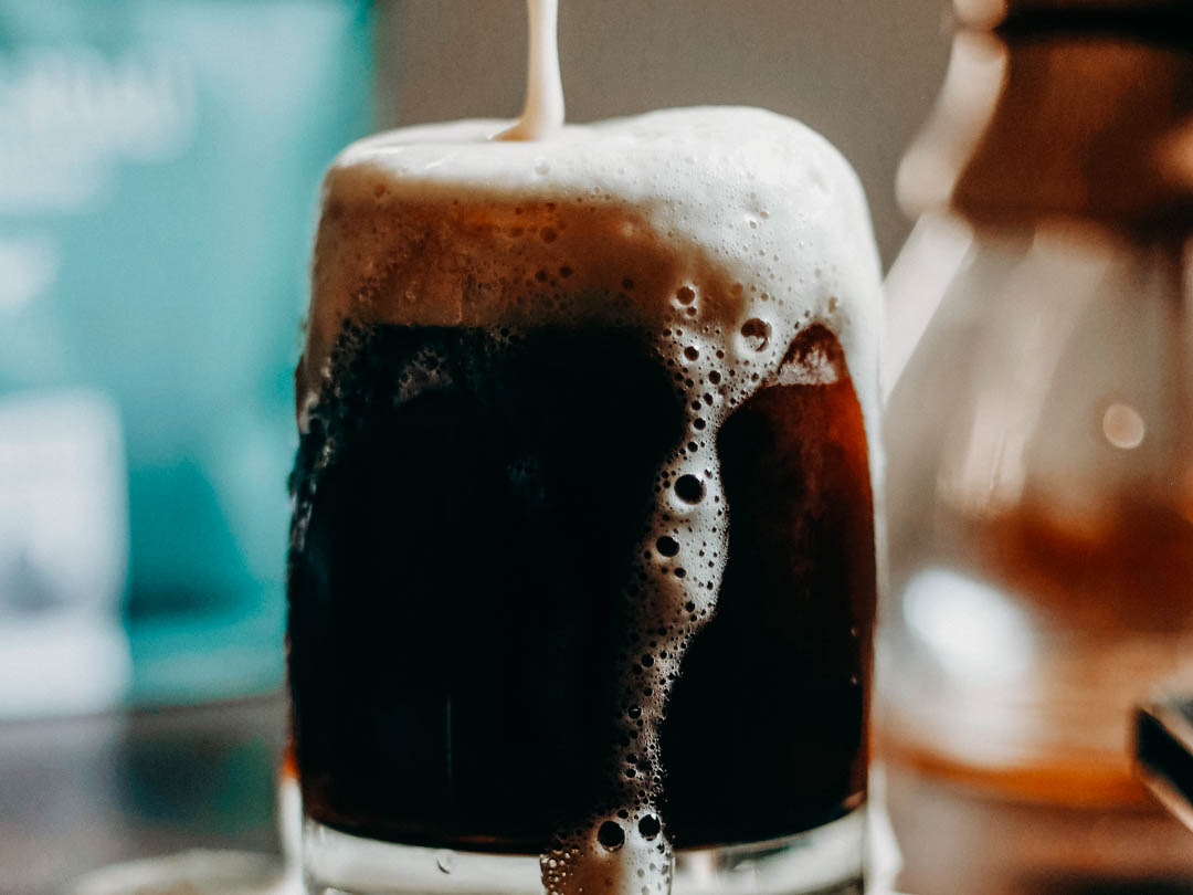 A glass of freshly made nitro cold brew at home