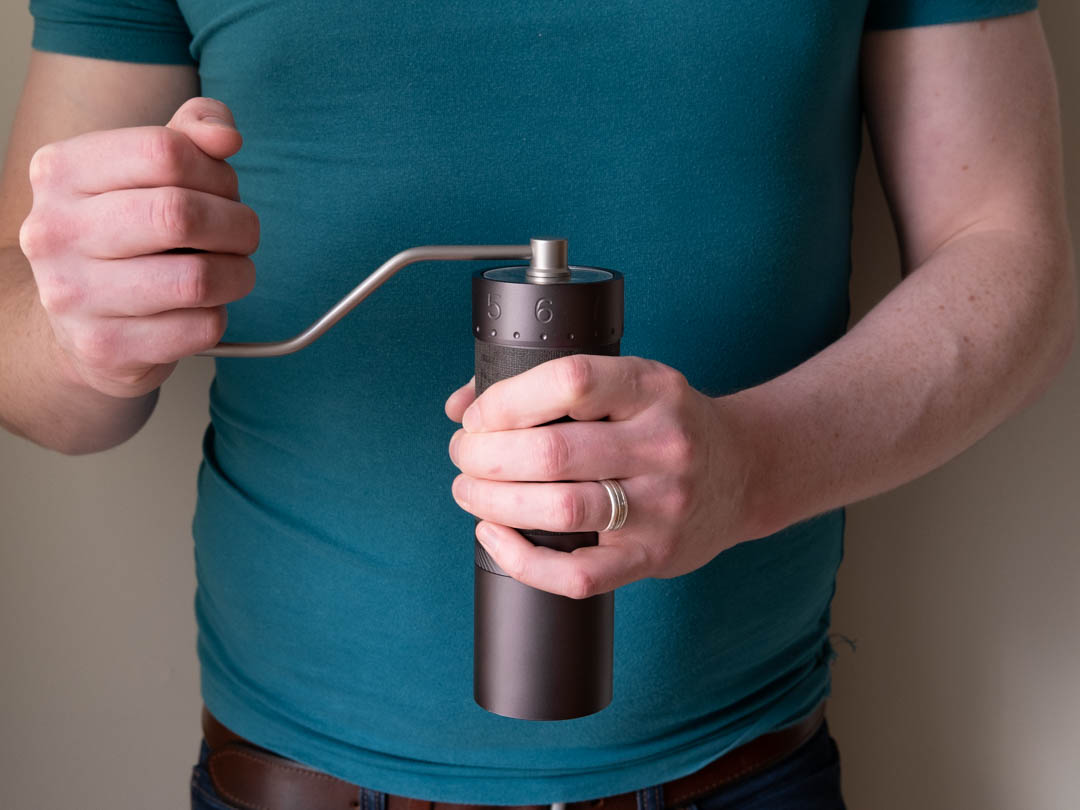 Man holding the 1Zpresso J Max - Top Choice for Manual Coffee Grinder