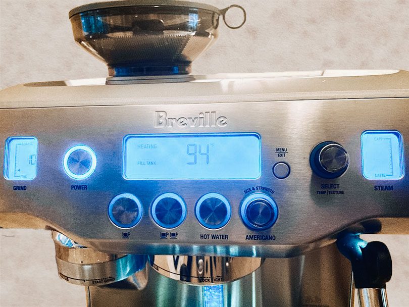 Close up of the LCD screen, buttons, and dials on the Breville Oracle espresso machine