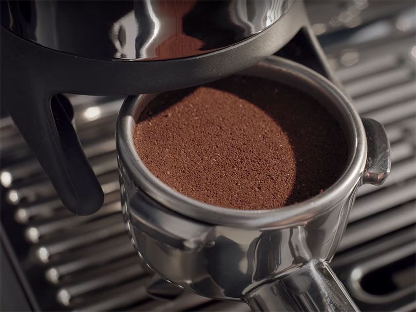 Close up of the auto-tamped coffee puck from the Barista Express Impress