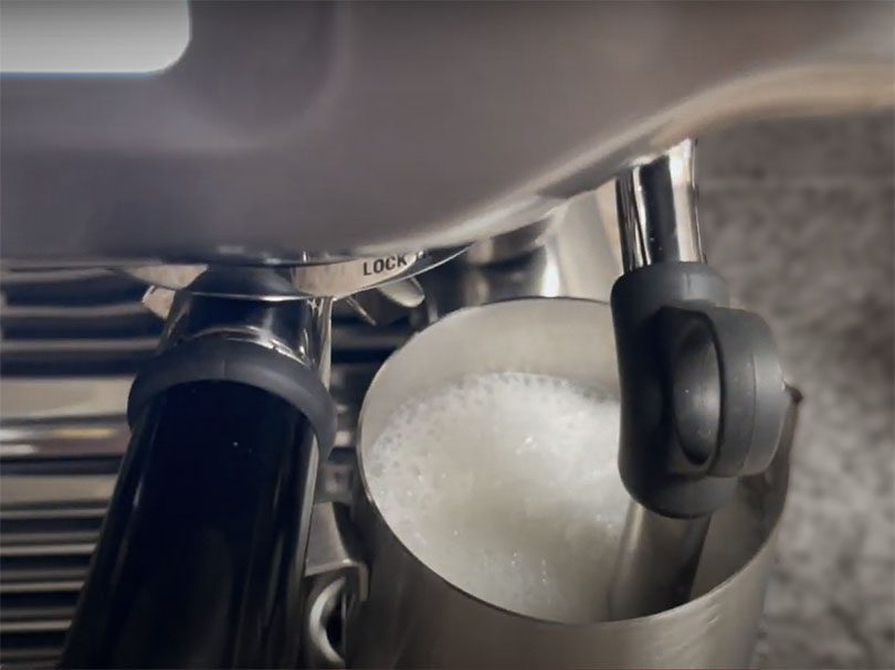 Close up of milk frothing on the Breville Barista Touch