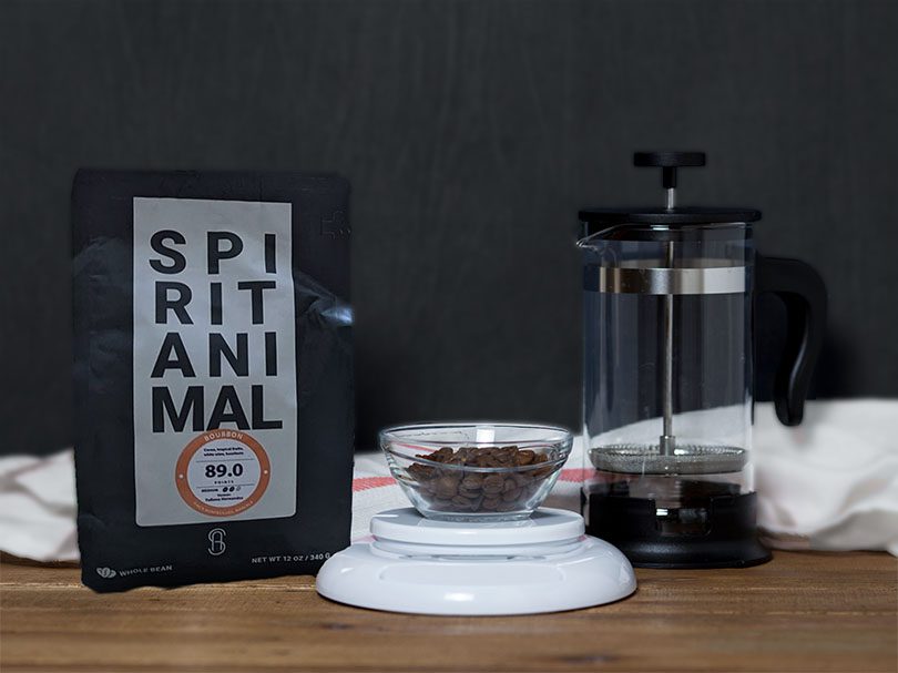 Bag of Spirit Animal (Boubon) coffee beans on table with a French press