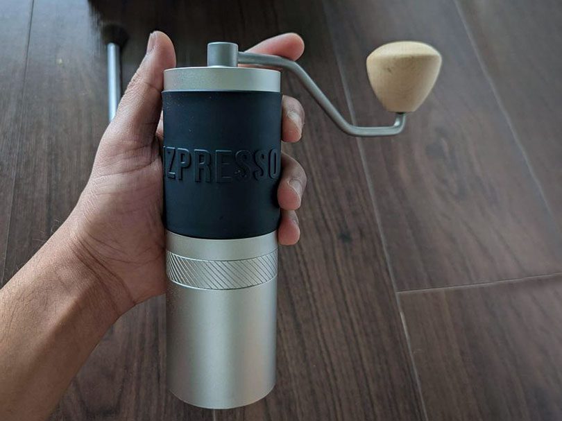 Hand holding the 1Zpresso JX Pro coffee grinder