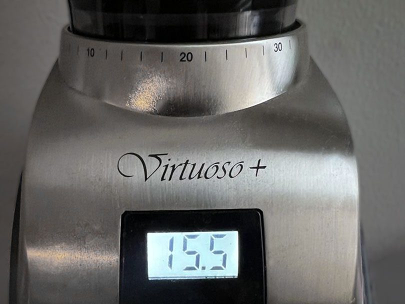 Close up of the grind adjustment dial and LED screen on the Baratza Virtuoso+ coffee grinder