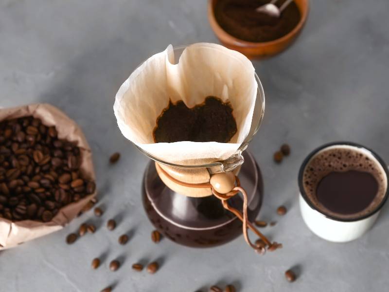 Chemex surrounded by coffee beans