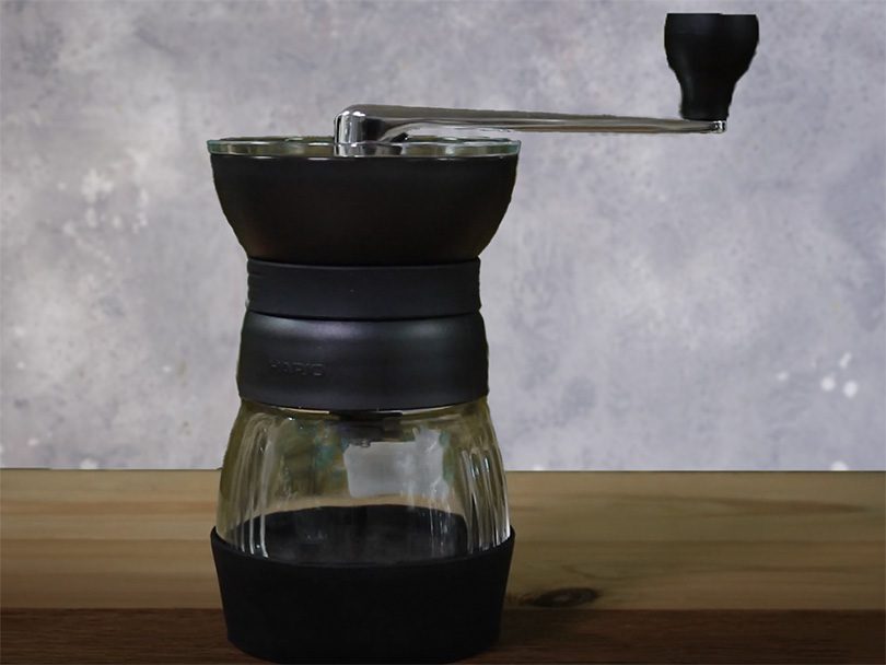 Hario Skerton Pro manual coffee grinder on wooden table