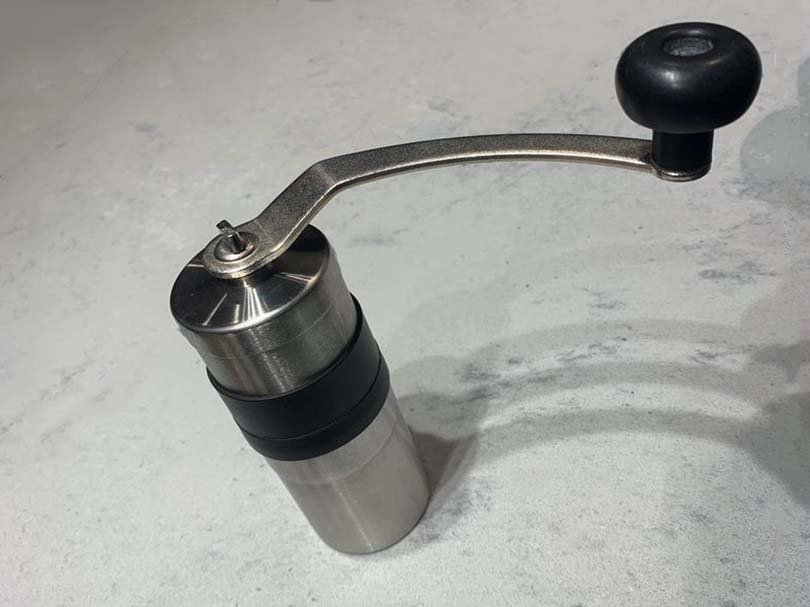 Porlex Mini with handle in place, sitting on kitchen counter