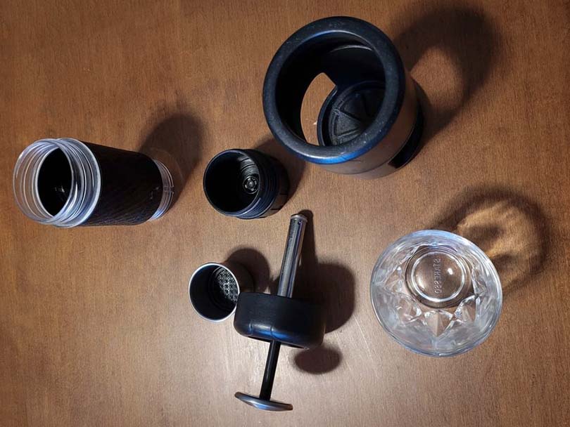 All the parts of the Staresso portable espresso maker laid out on a table
