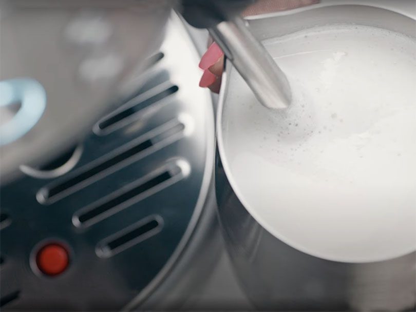 Close up of creating milk microfoam using the Breville Bambino