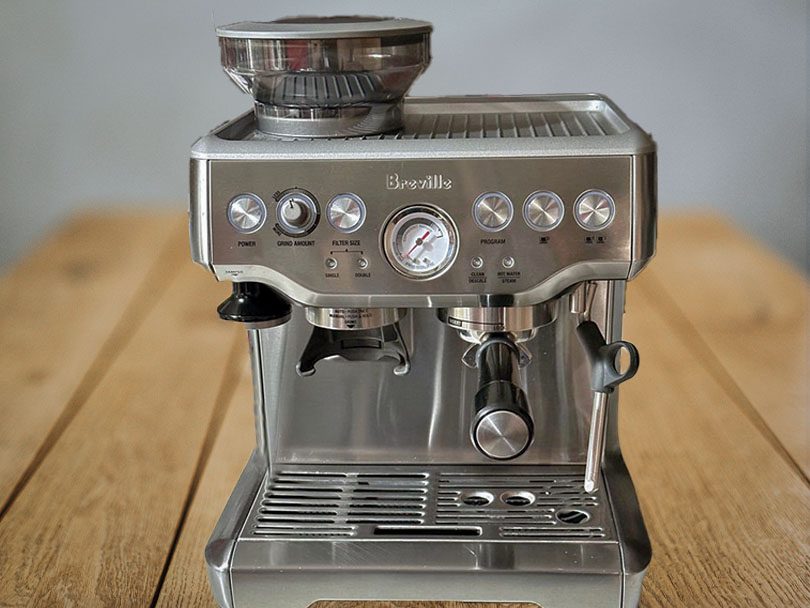 Full view of the Breville Barista Express, sitting on a wooden table