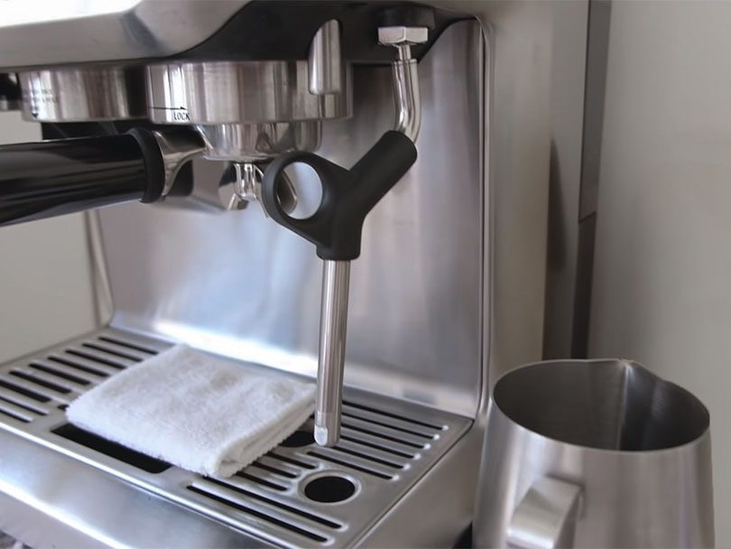 Side view of the Breville Barista Express showing the milk wand