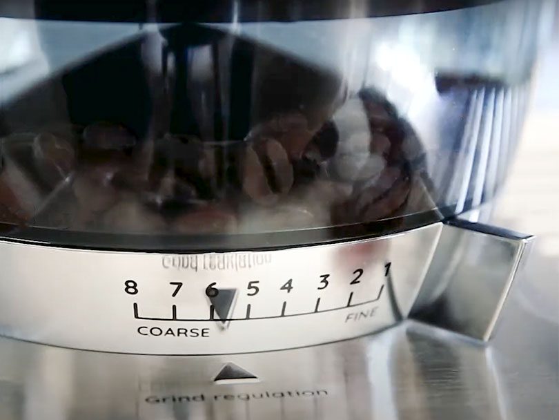 Close up of the bean hopper and grind adjustment dial on the DeLonghi La Specialista Arte