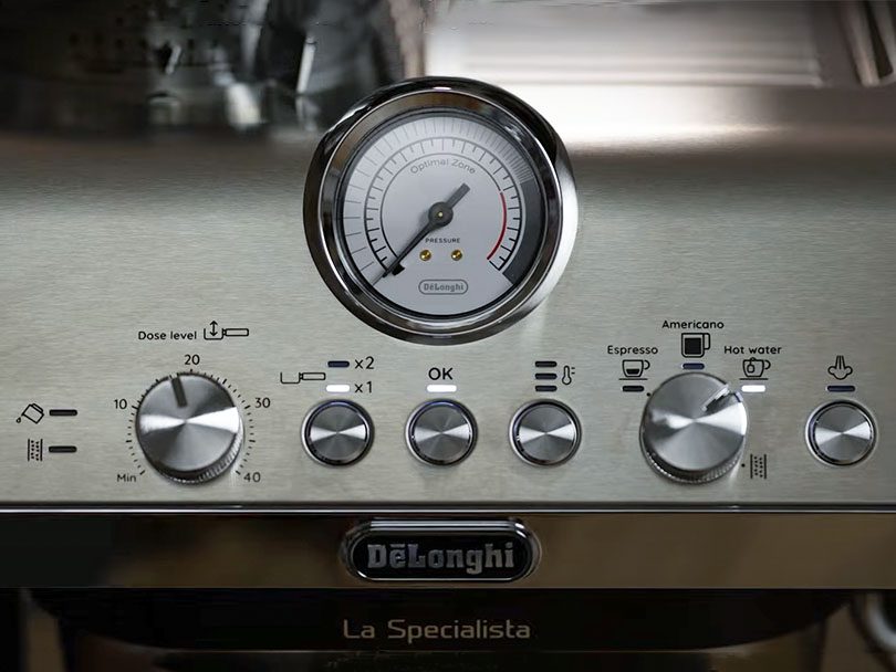 Close up of the buttons, dials, and pressure gauge on the DeLonghi La Specialista Arte