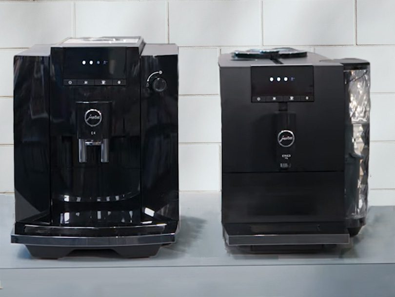 Jura E4 and ENA 4 sitting side by side on kitchen cabinet