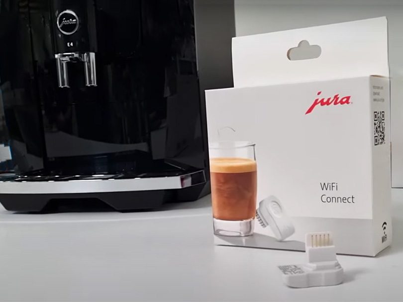 Jura WiFi Connect sitting in front of the E4 automatic coffee machine
