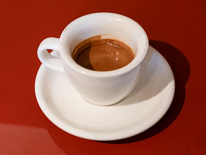 Cup of espresso on a red table