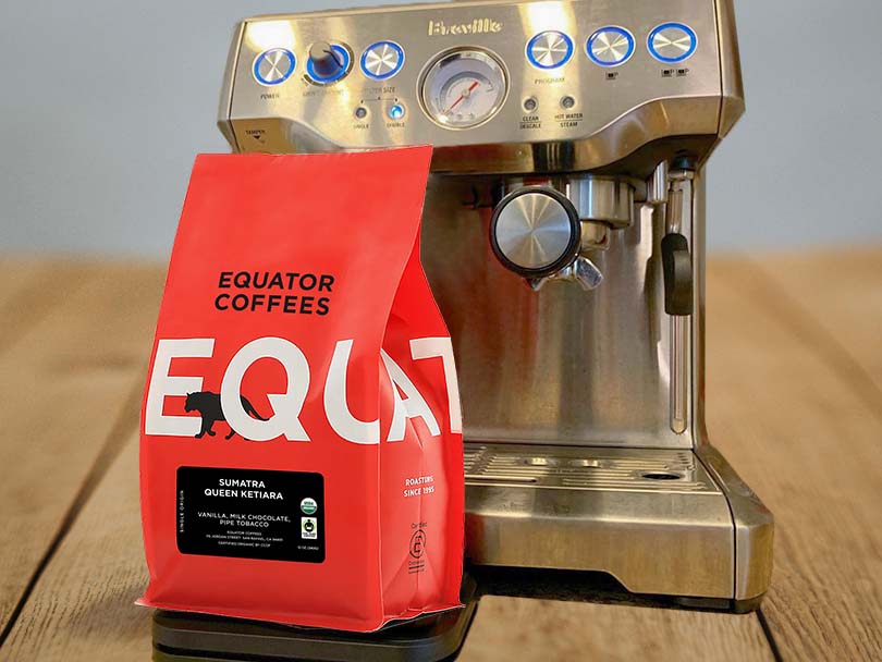 Bag of Equator Coffee Beans in front of espresso machine