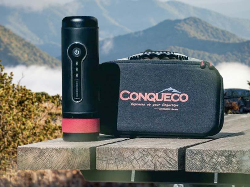 Conqueco portable espresso maker, 12V battery operated on campsite table