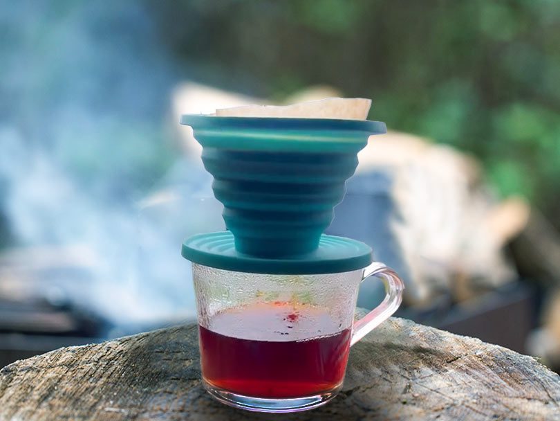 Collapsible pour over coffee maker being used whilst camping