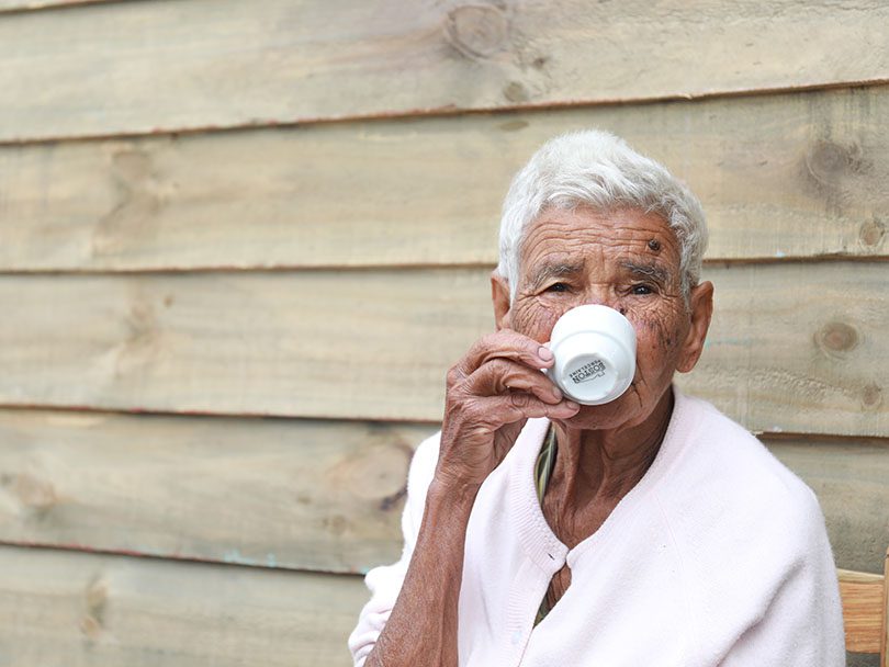 Woman from the Dominican Republic drinking a cup of coffee