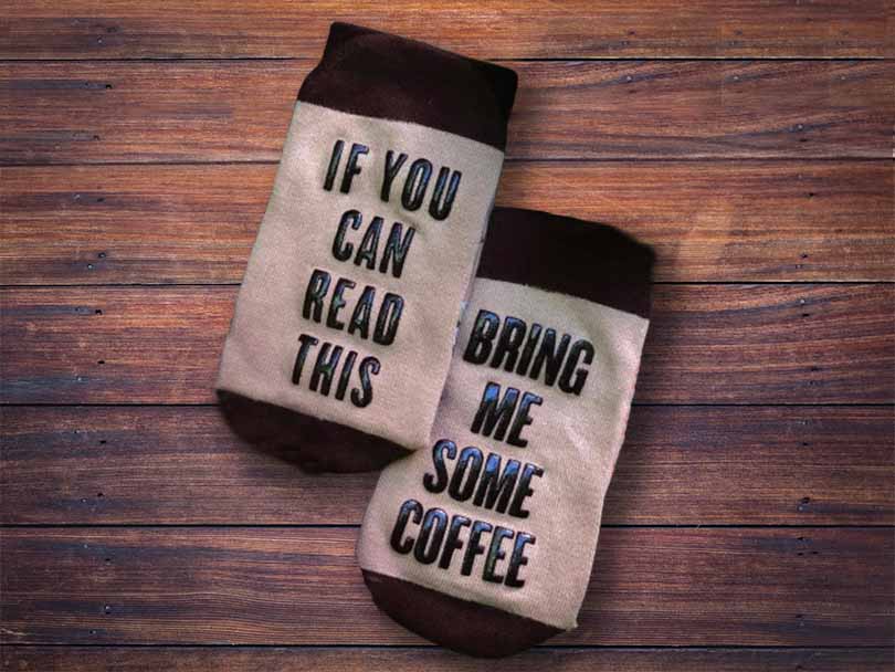 Novelty coffee socks make a perfect gift. They say "If you can read this, bring me some coffee"
