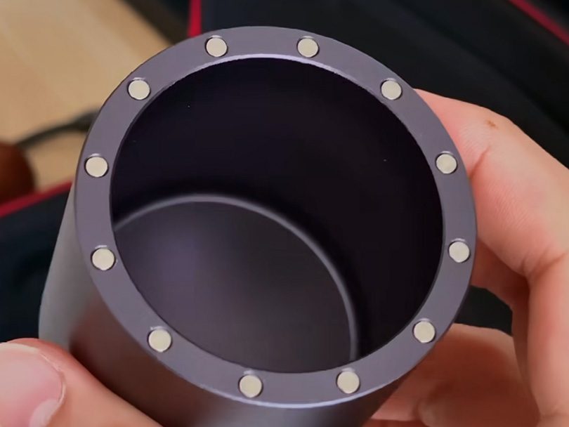 Holding the K Ultra's magnetic grounds catch cup (empty) towards the camera