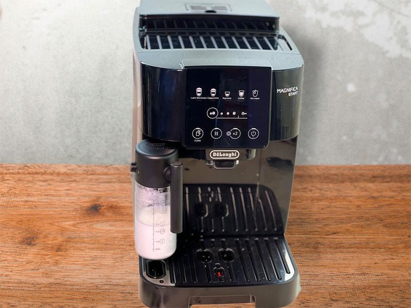 DeLonghi Magnifica Start (black) with LatteCrema sitting on a wooden counter