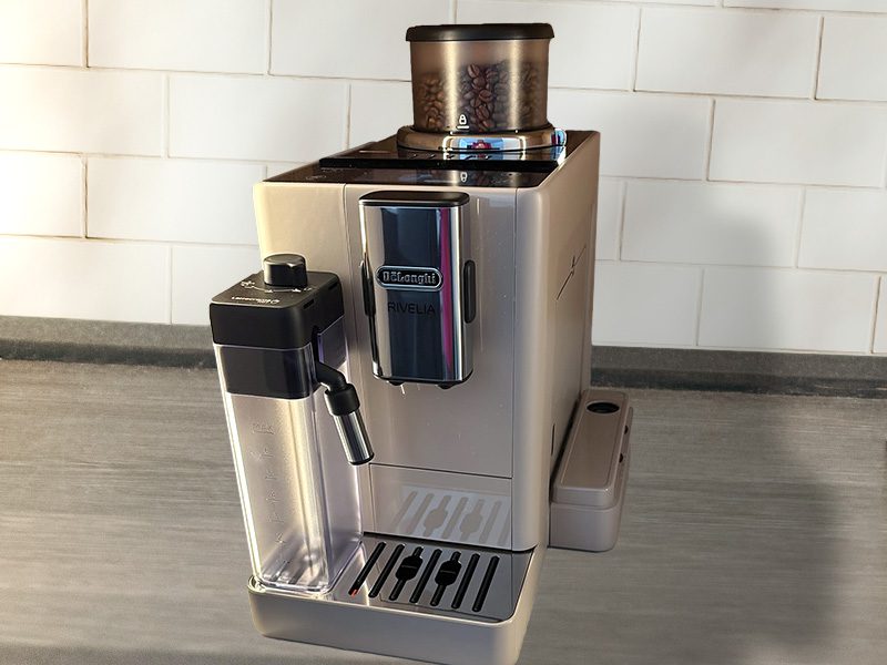 Front view of the DeLonghi Rivelia on wooden counter