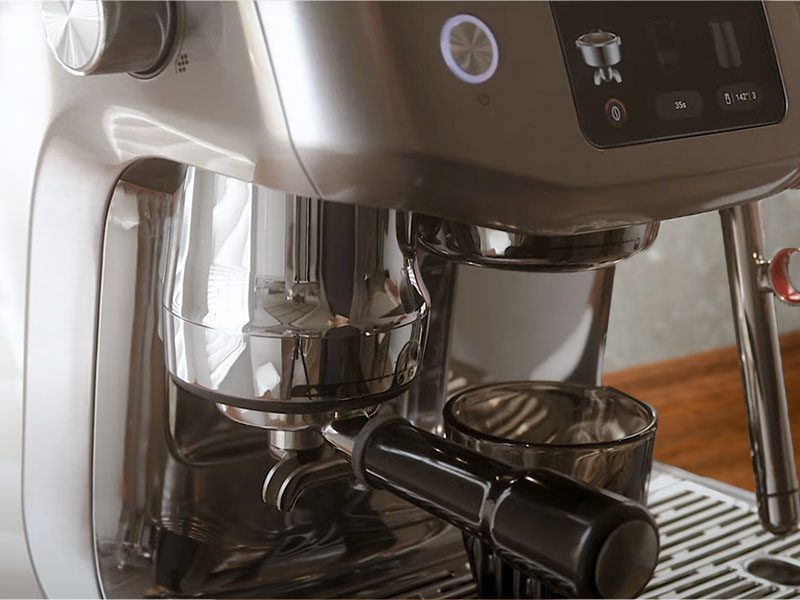 Side view of the Breville Oracle Jet midway through auto-dosing and tamping the freshly ground coffee